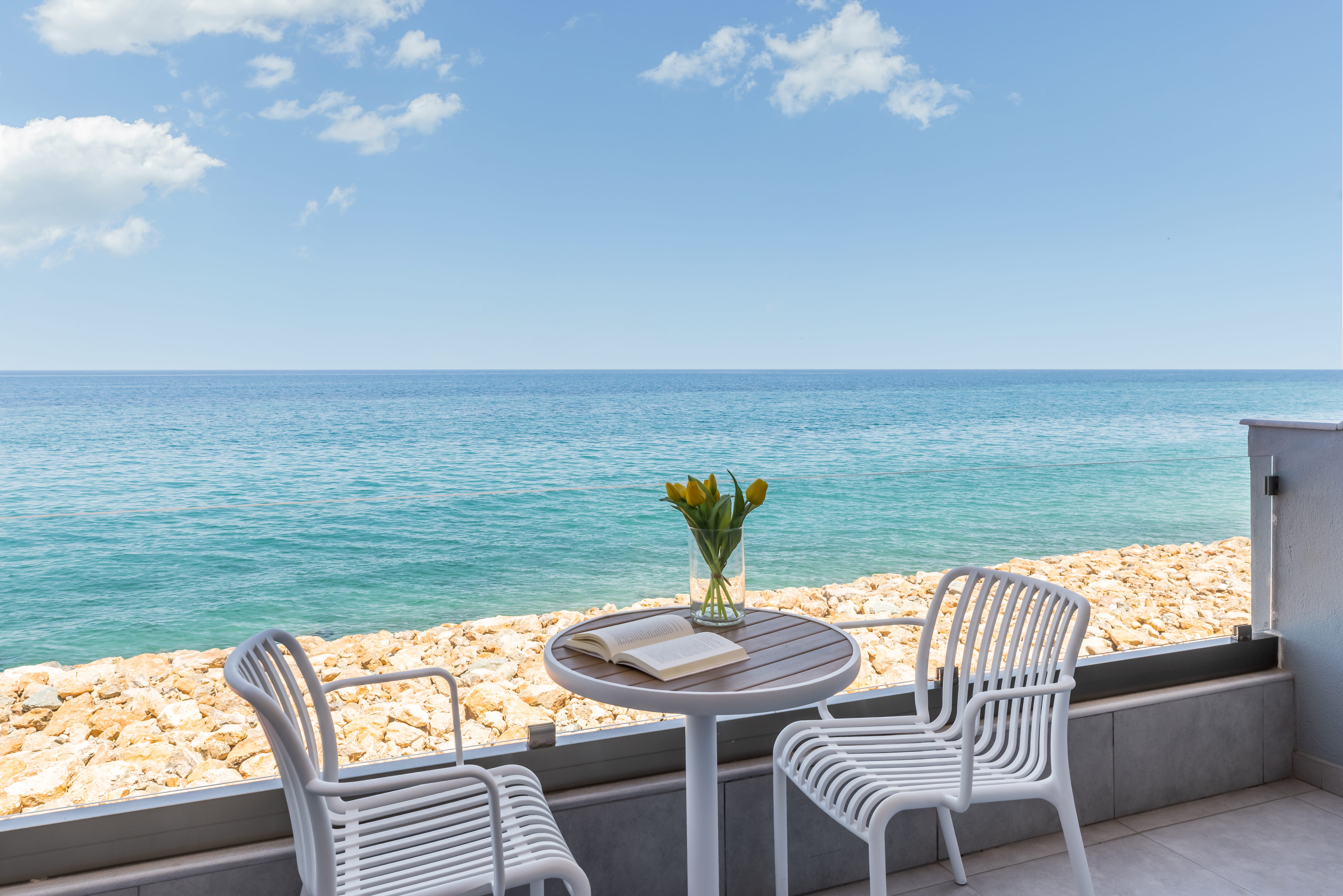 a table and chairs on a beach