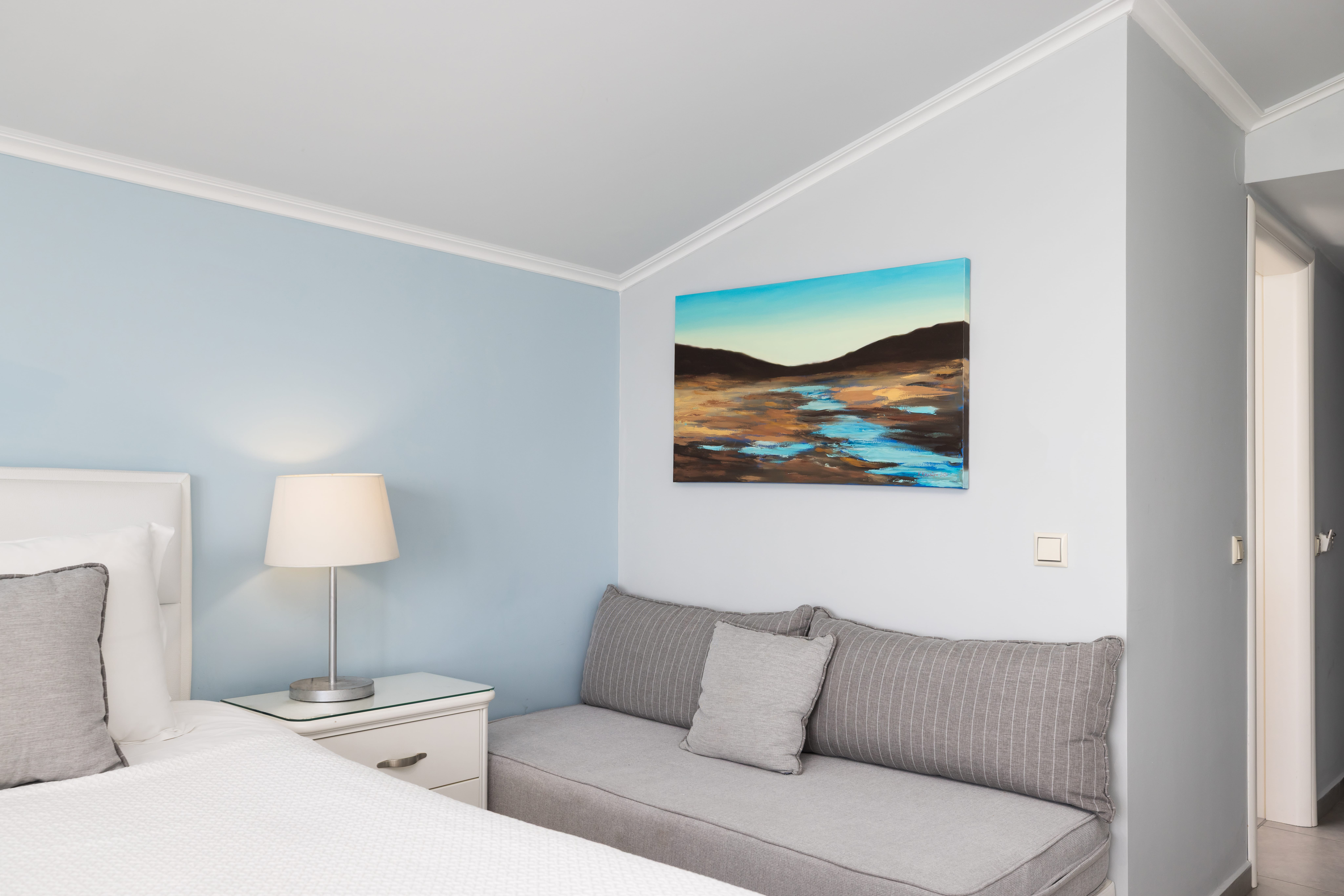 a bedroom with a bed and a lamp