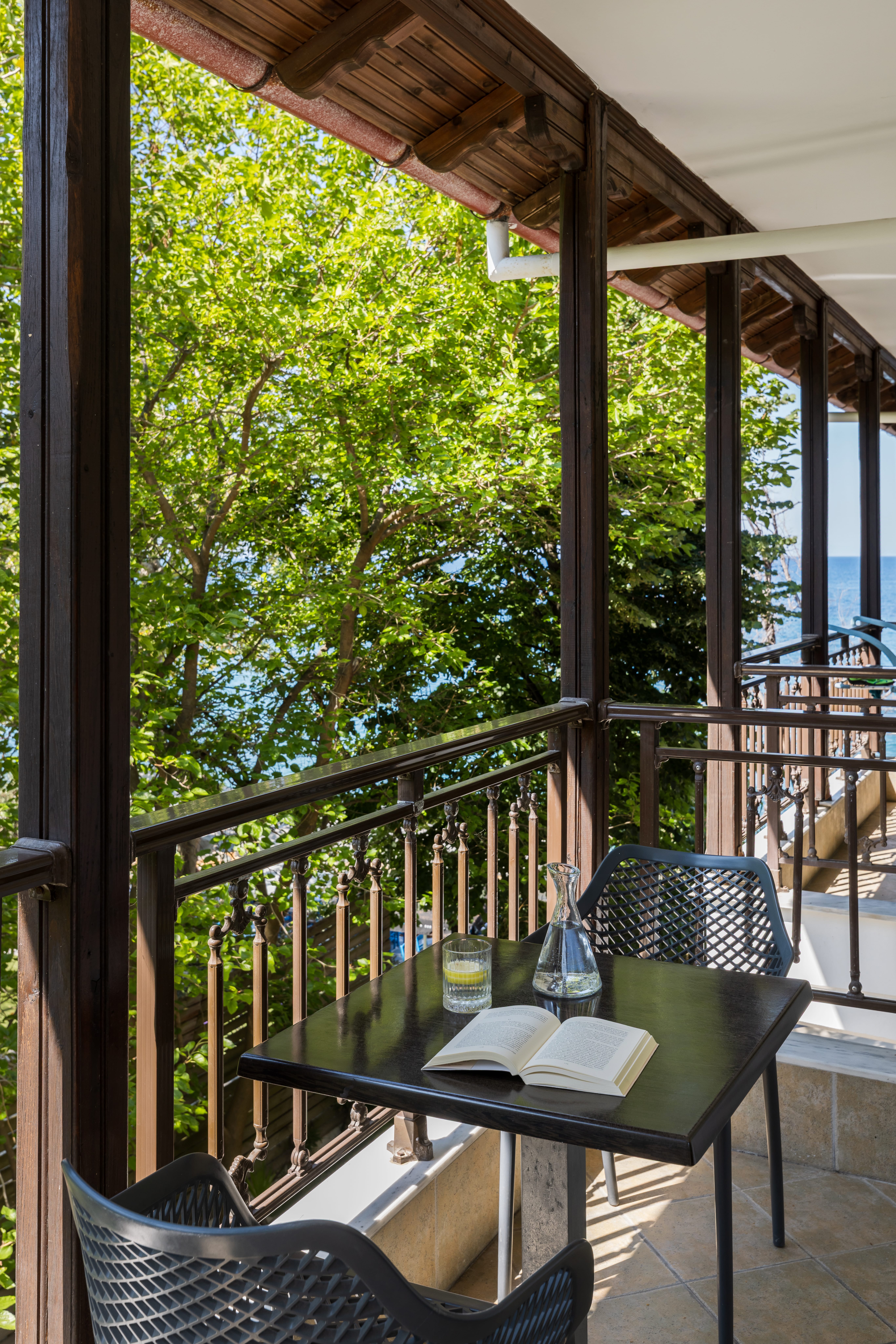 a table with a glass and a glass on it by a window