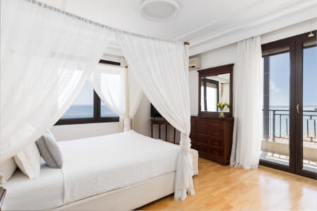 a bedroom with a bed and a large window