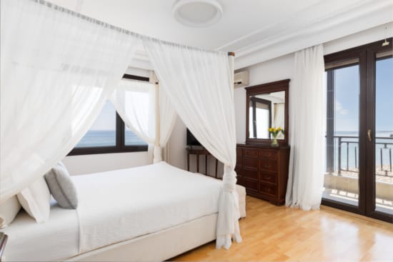 a bedroom with a bed and a large window