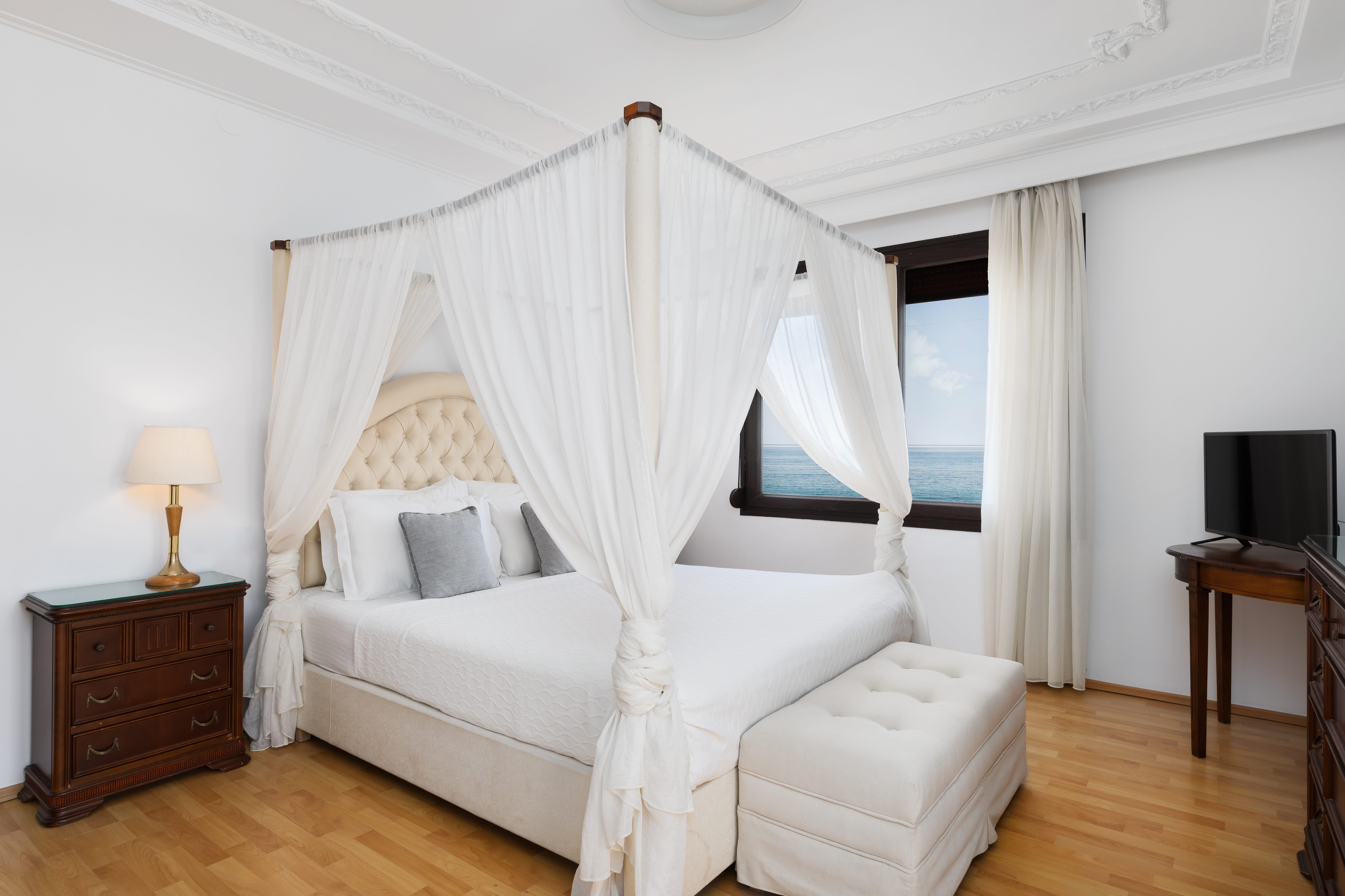 a bed with white curtains