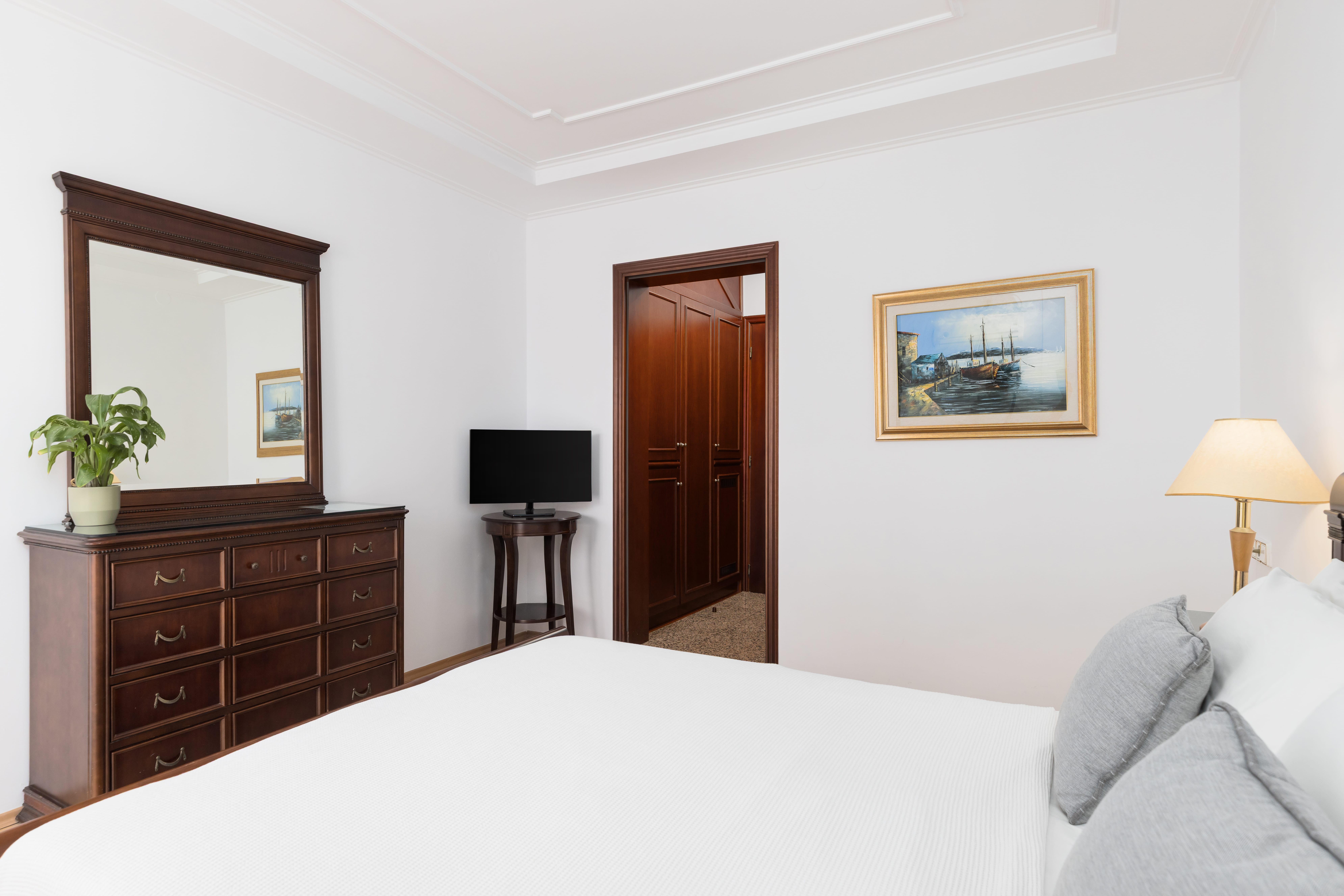 a bedroom with a bed and a dresser