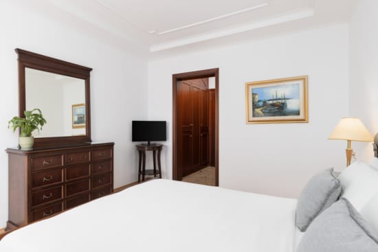 a bedroom with a bed and a dresser