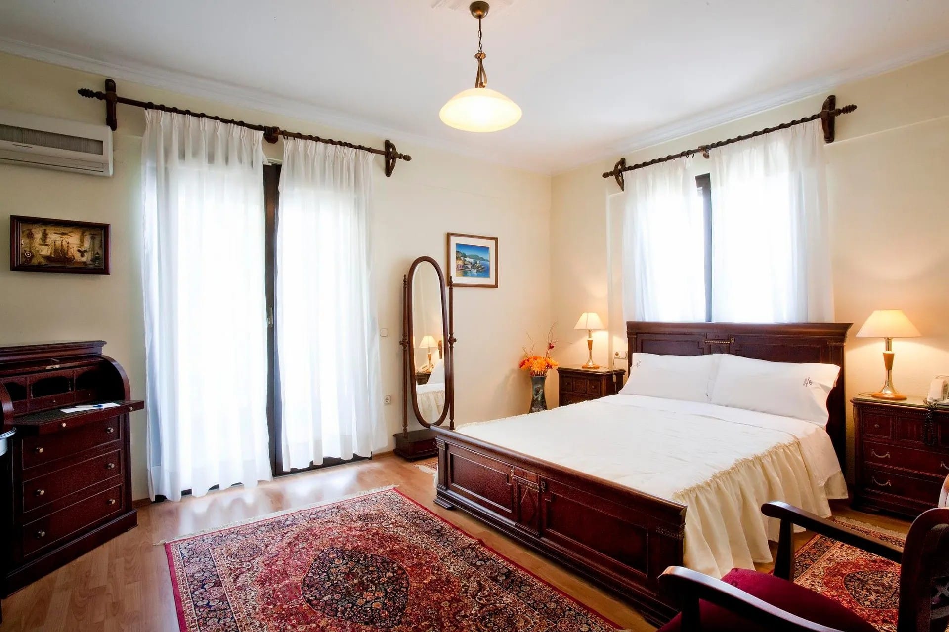 a bedroom with a bed and a mirror