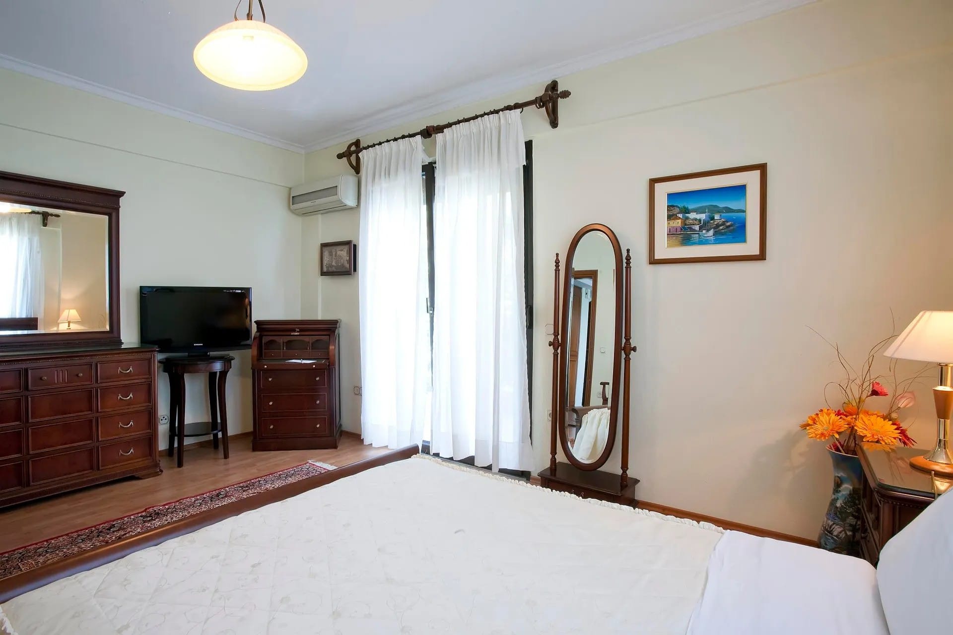 a room with a mirror and a bed