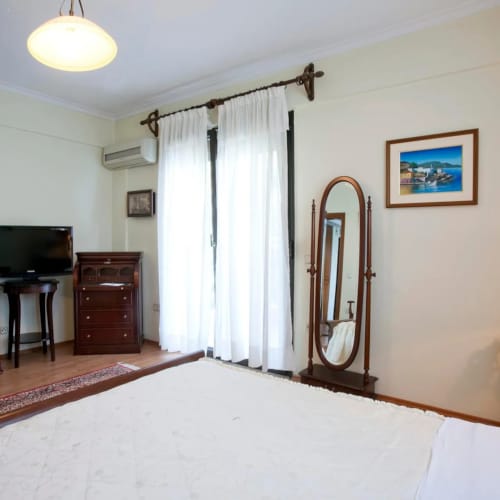 a room with a mirror and a bed