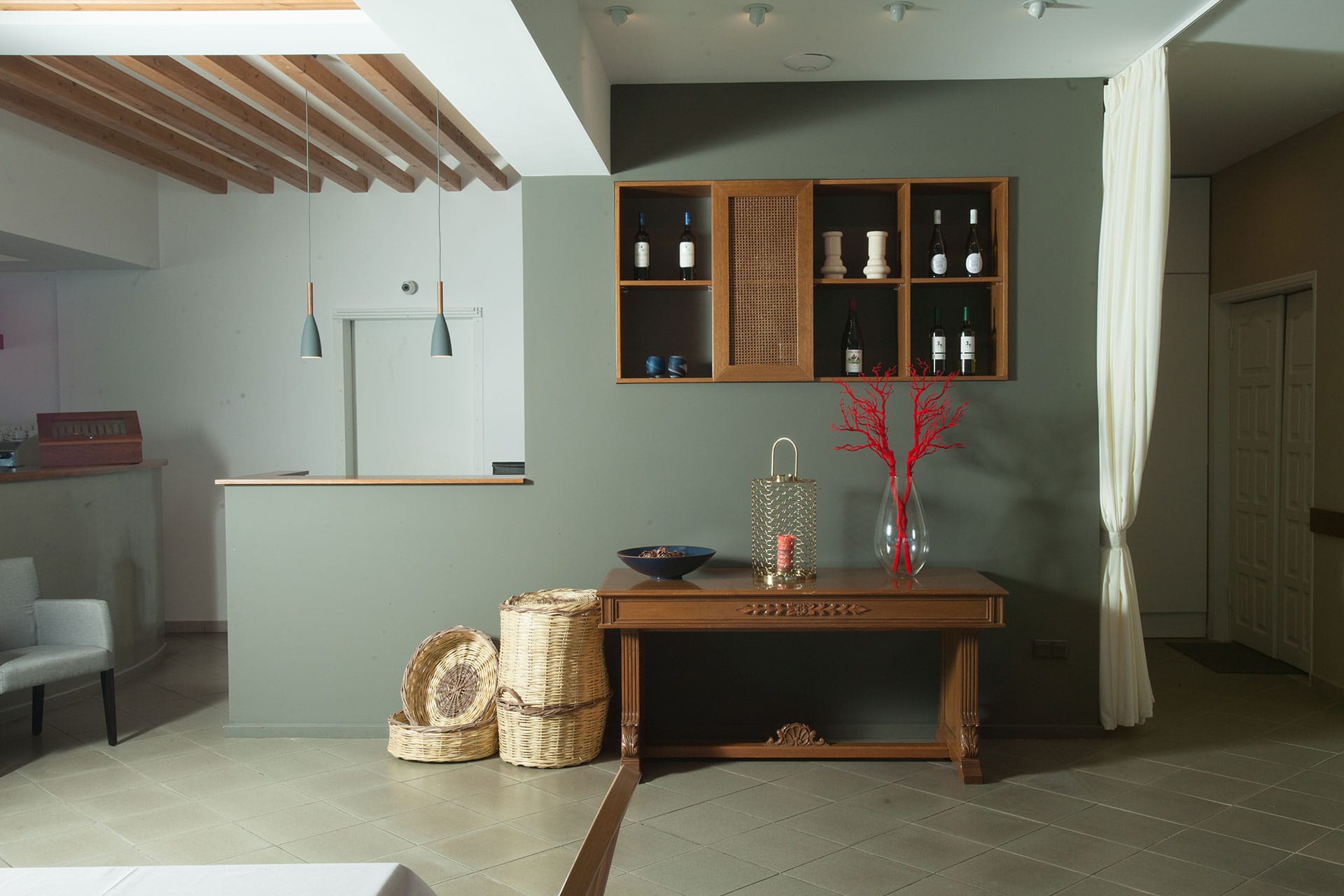 a living room with a table and a vase with flowers on it