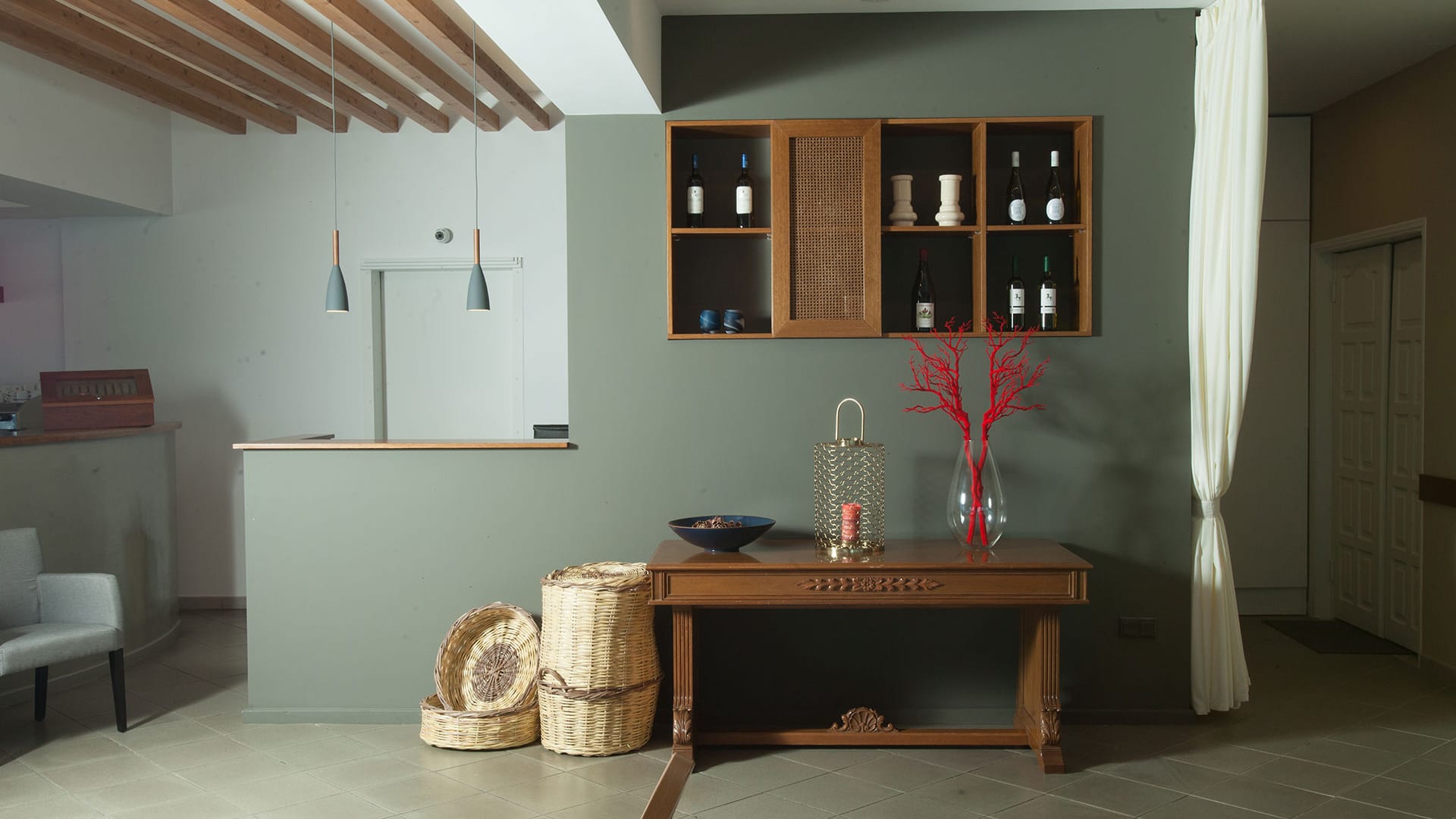 a living room with a table and a vase with flowers on it