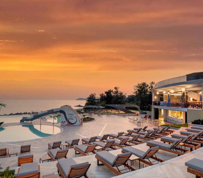 a pool with lounge chairs by it