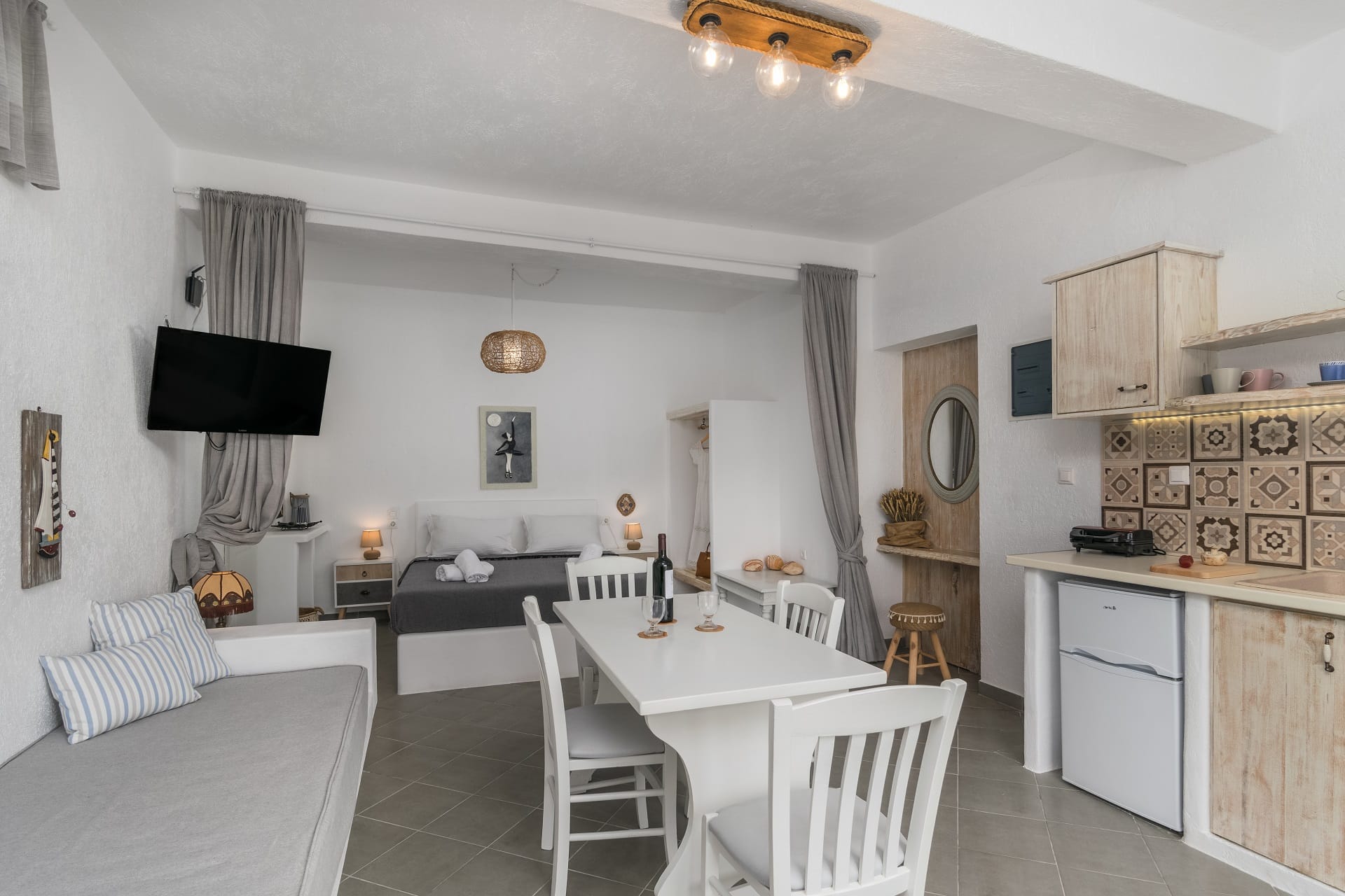 a living room with a tv and dining table