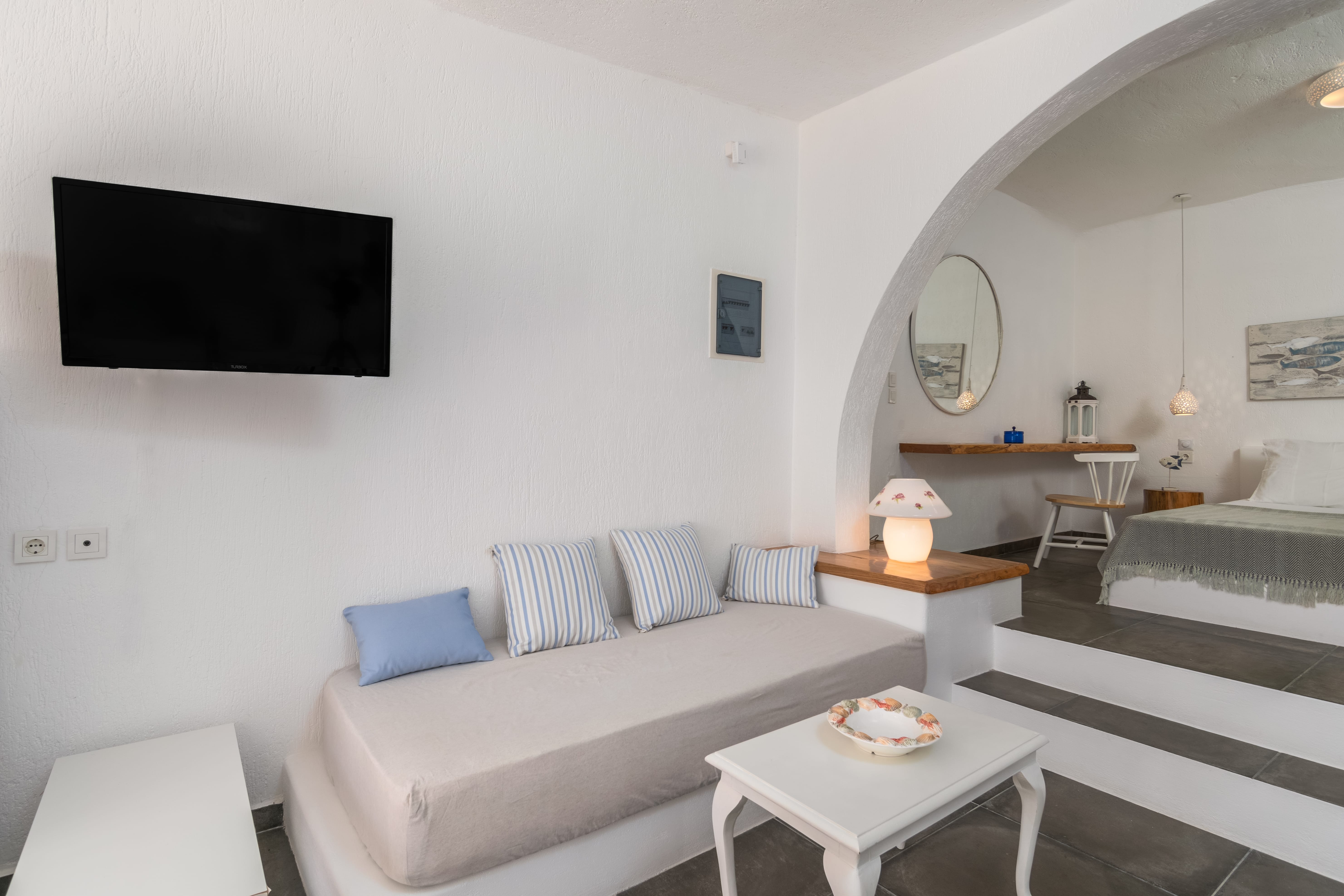 a living room with a tv and couches