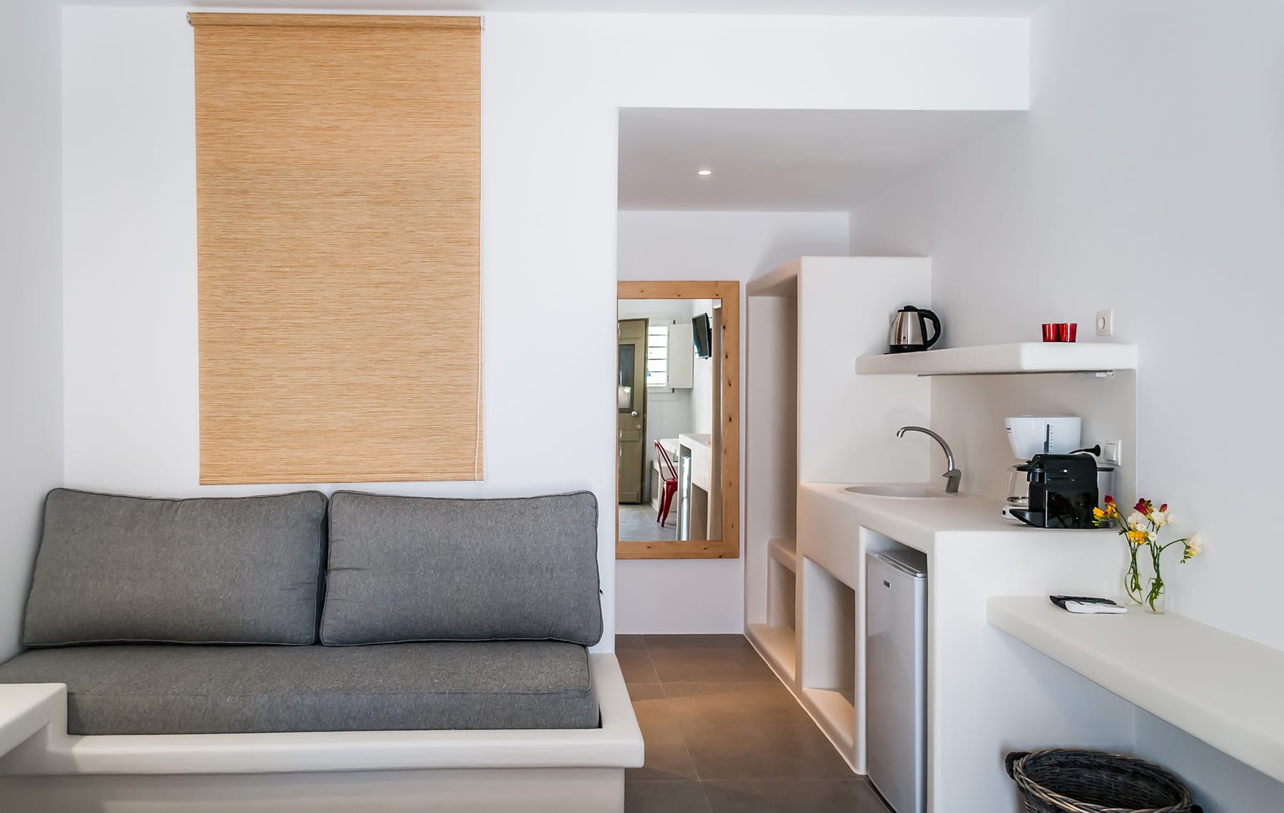 a living room with a couch and a sink