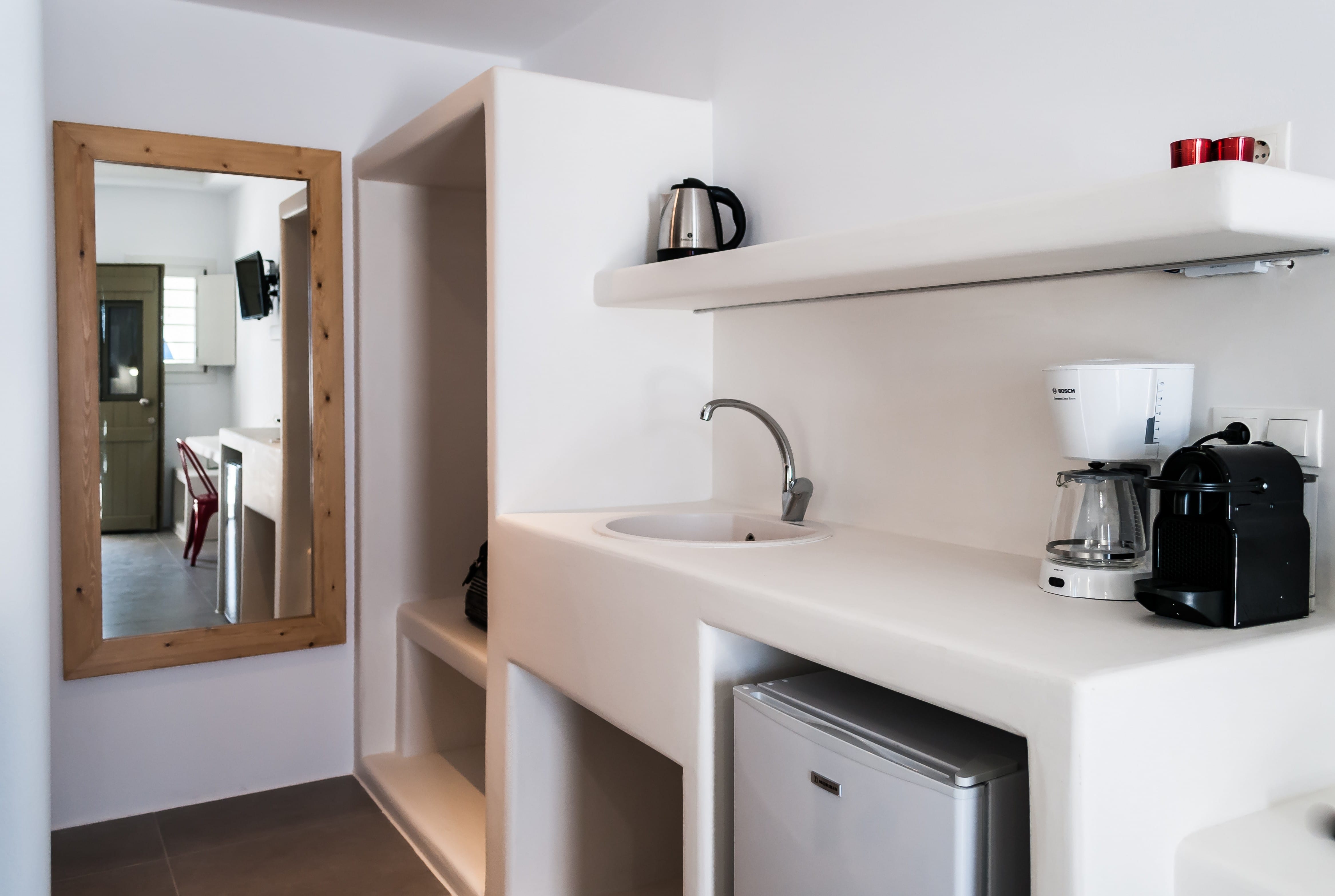 a kitchen with a sink and a coffee maker