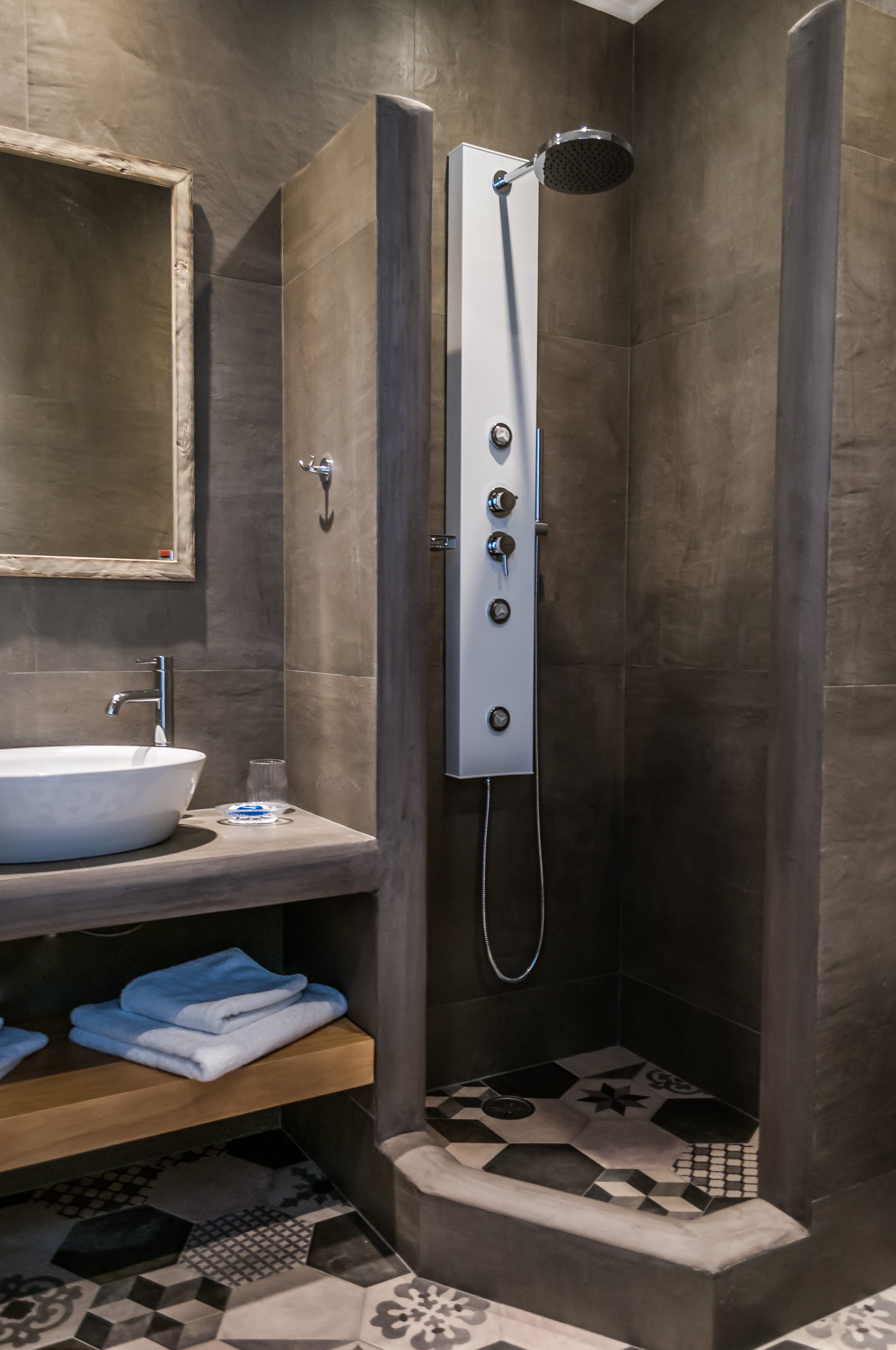 a bathroom with a shower unit and sink