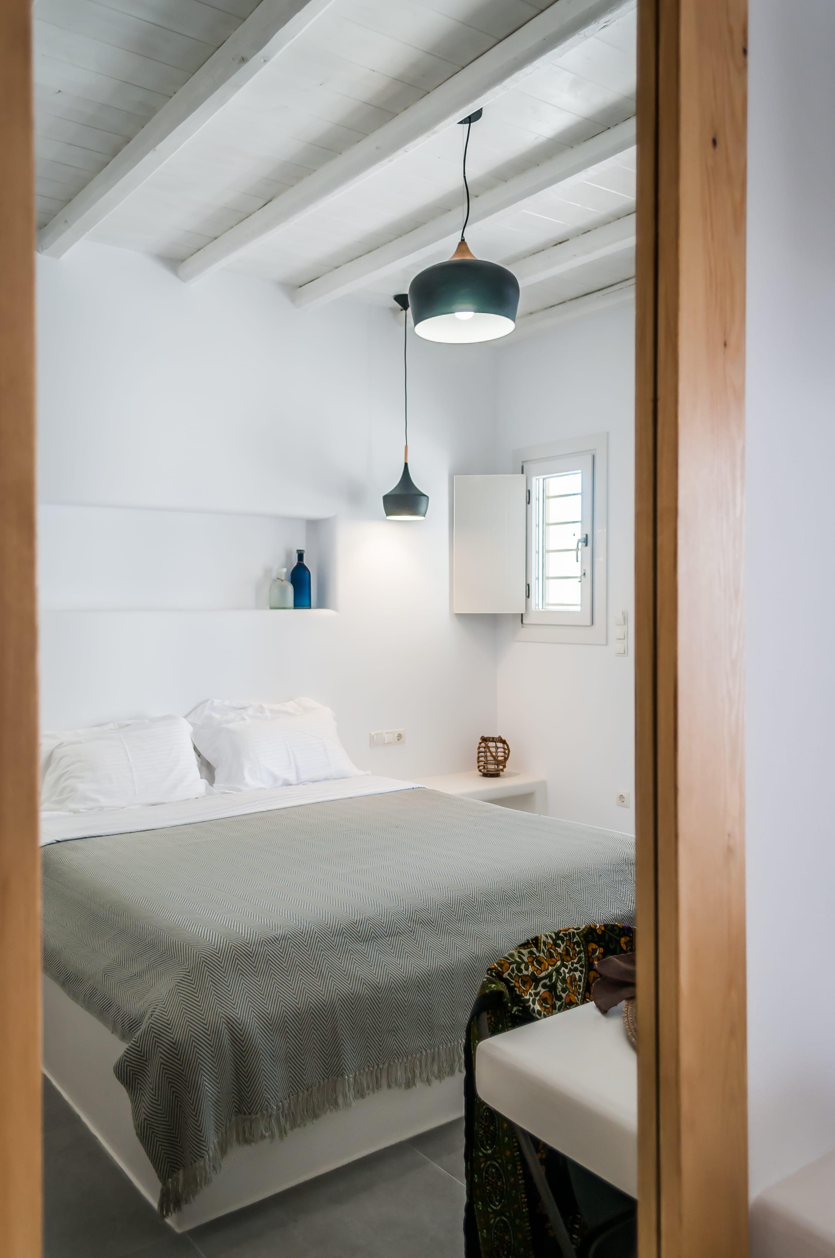 a bedroom with a bed and a lamp