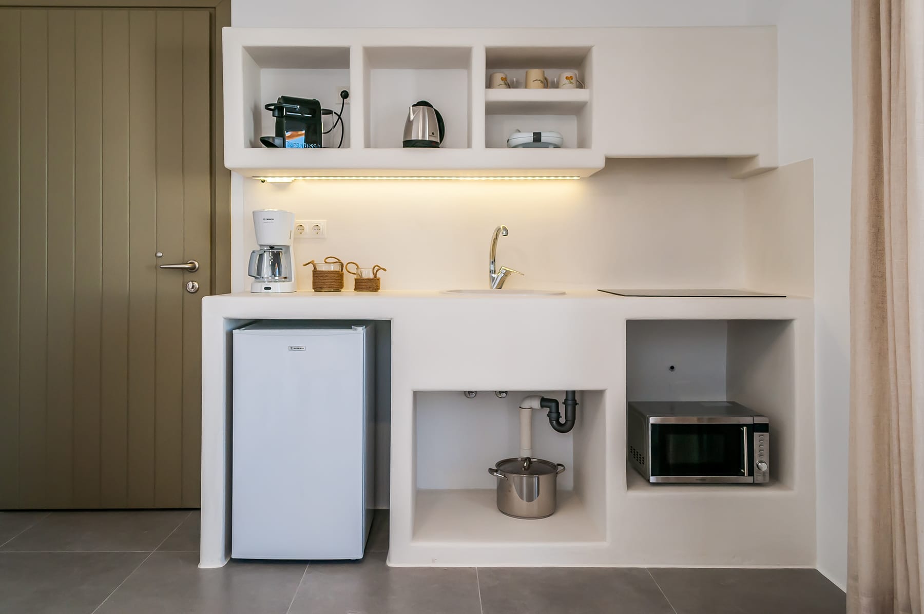 a small kitchen with white cabinets