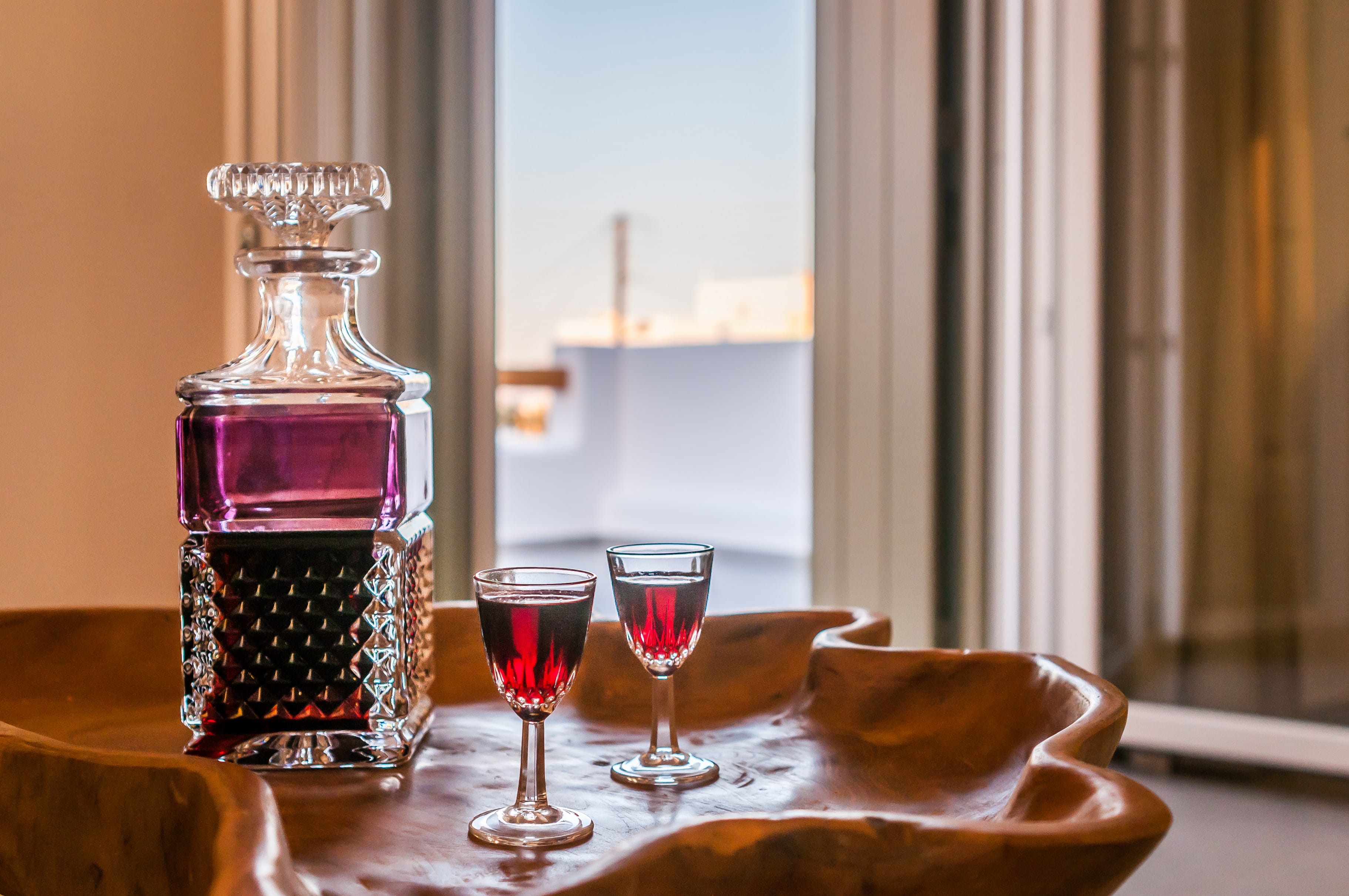 a table with glasses of red liquid and a salt shaker