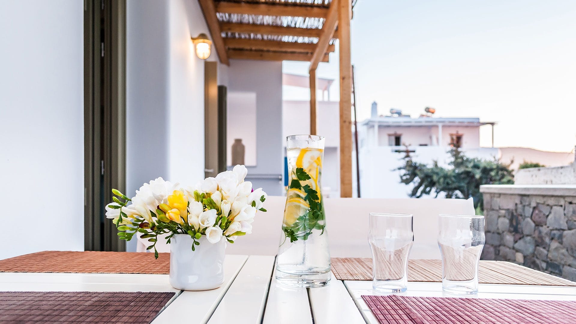 a table with glasses and flowers