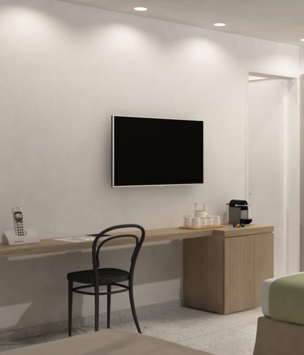 a hotel room with a tv and bed