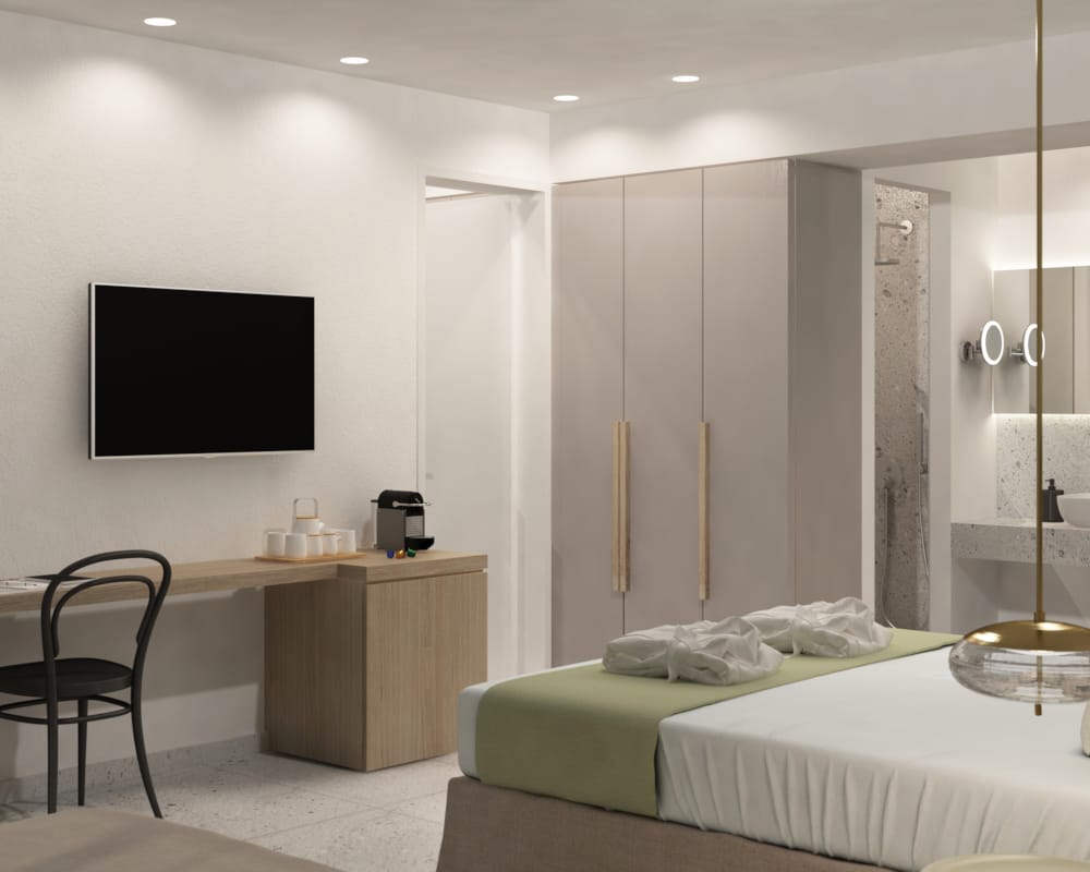 a hotel room with a tv and bed