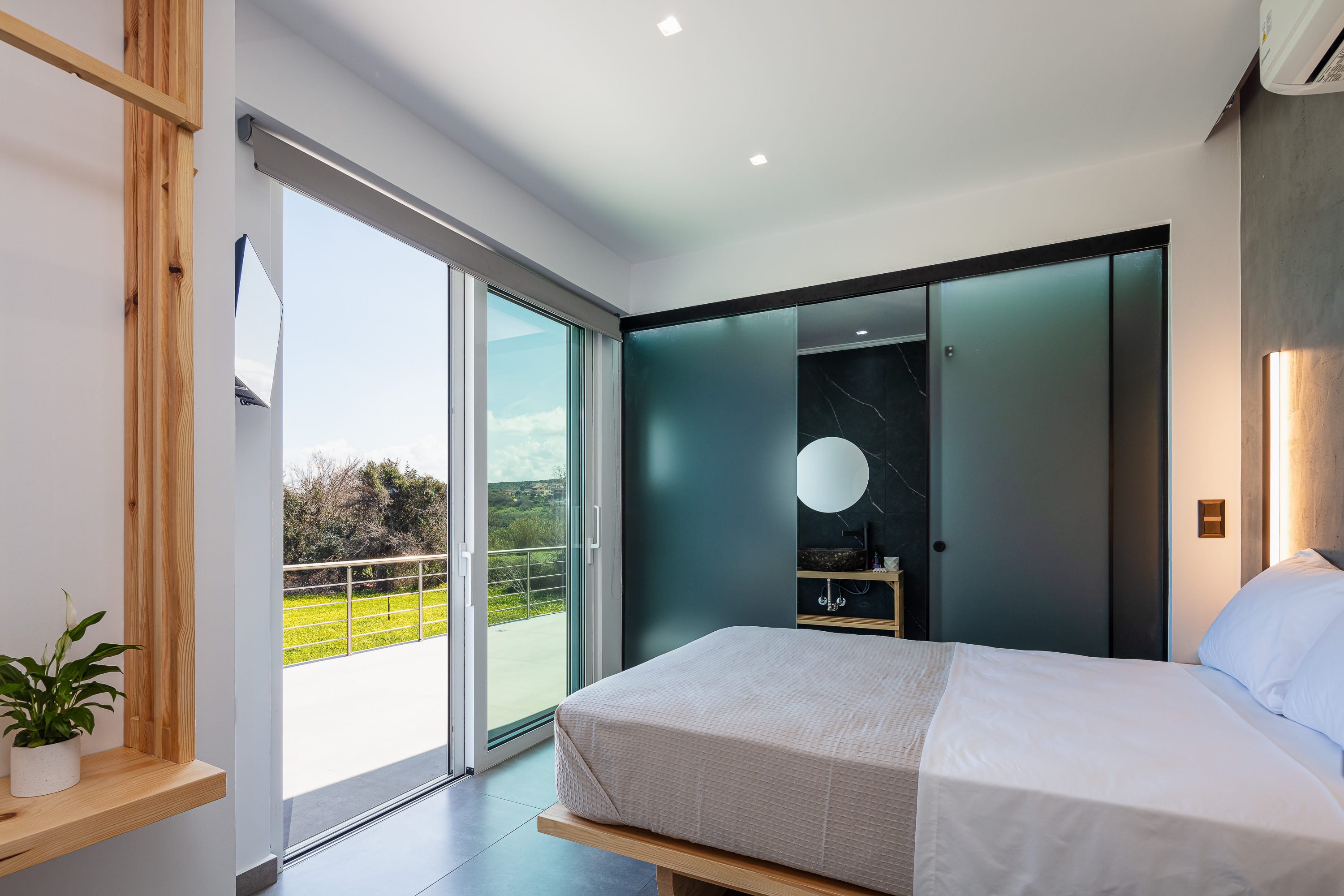 a bedroom with a large glass door