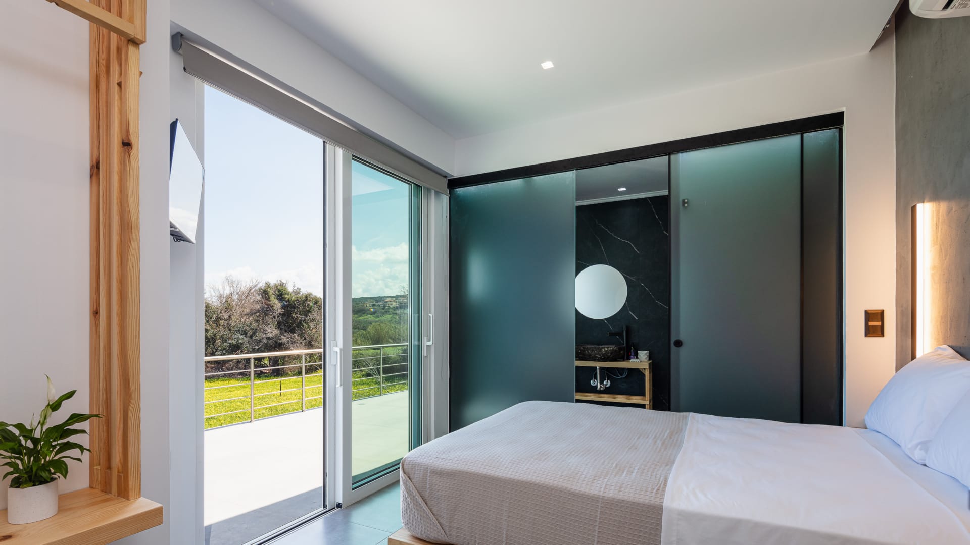 a bedroom with a large glass door