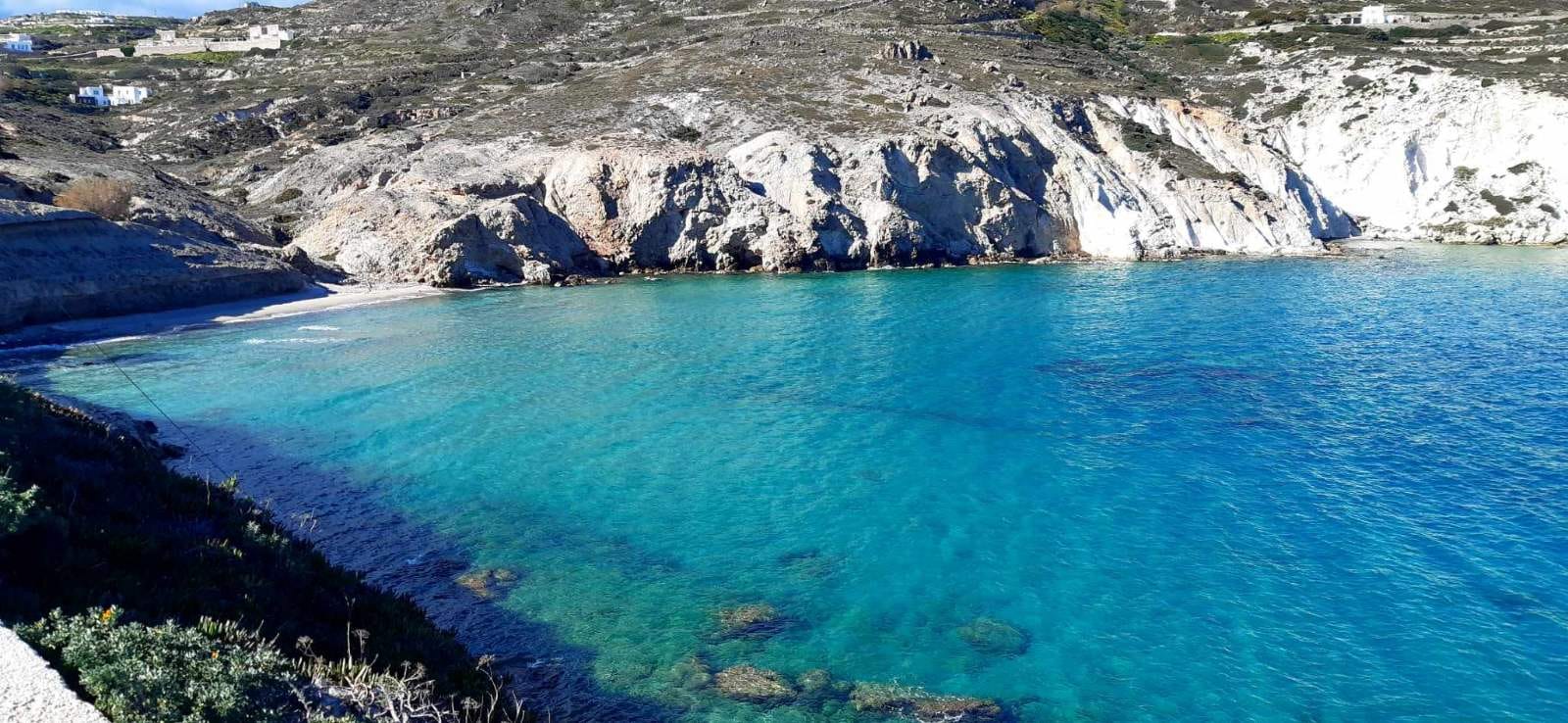 a body of water with a rocky shoreline