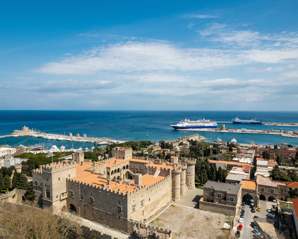 a city with a body of water in the background