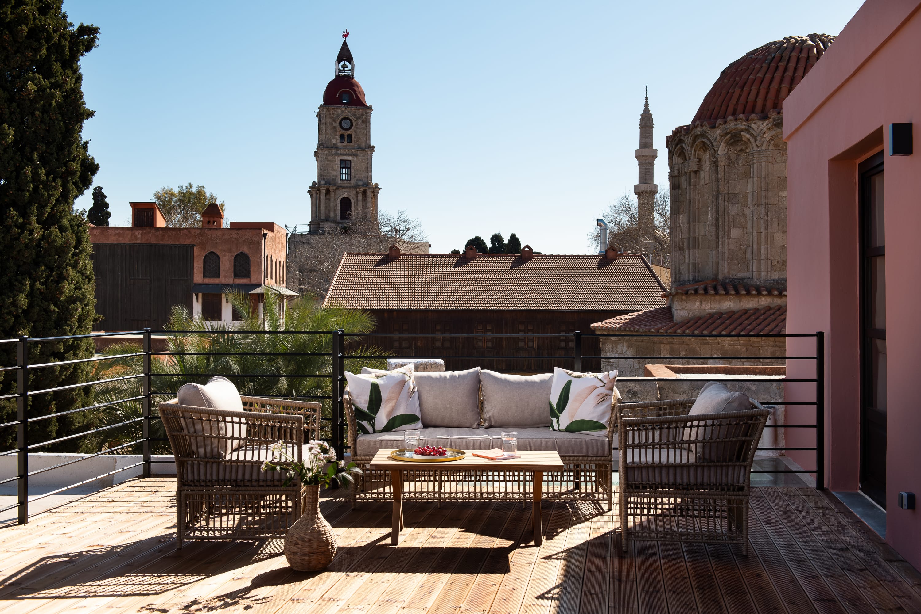 a patio with a table and chairs and a tower in the background