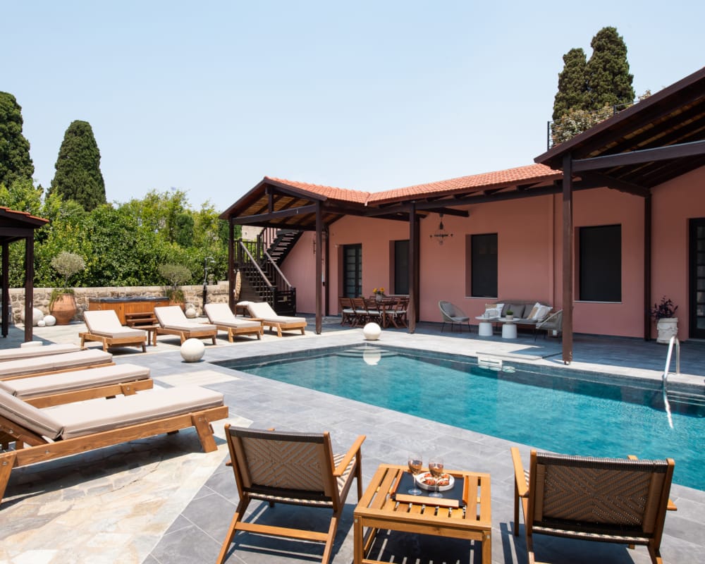 a swimming pool with chairs around it