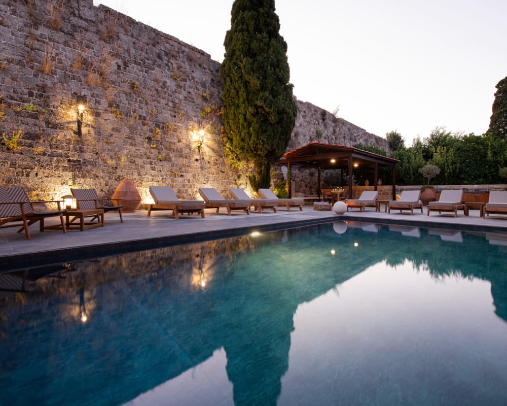 a pool with chairs around it