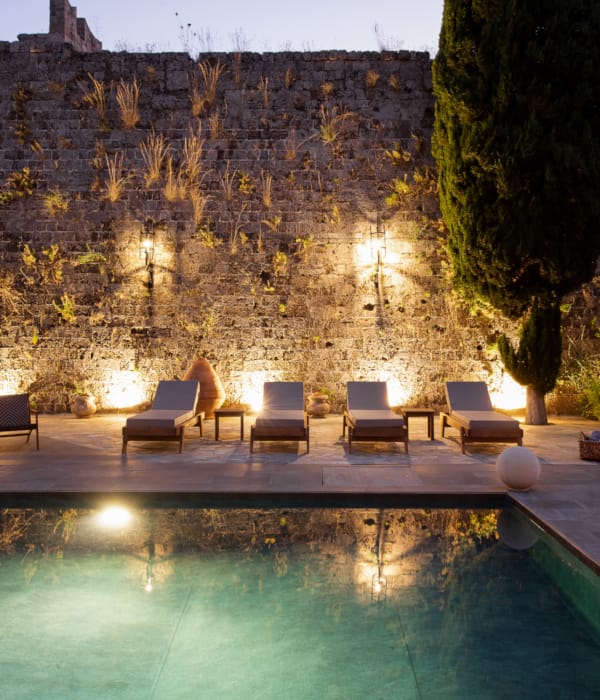 a pool with chairs around it