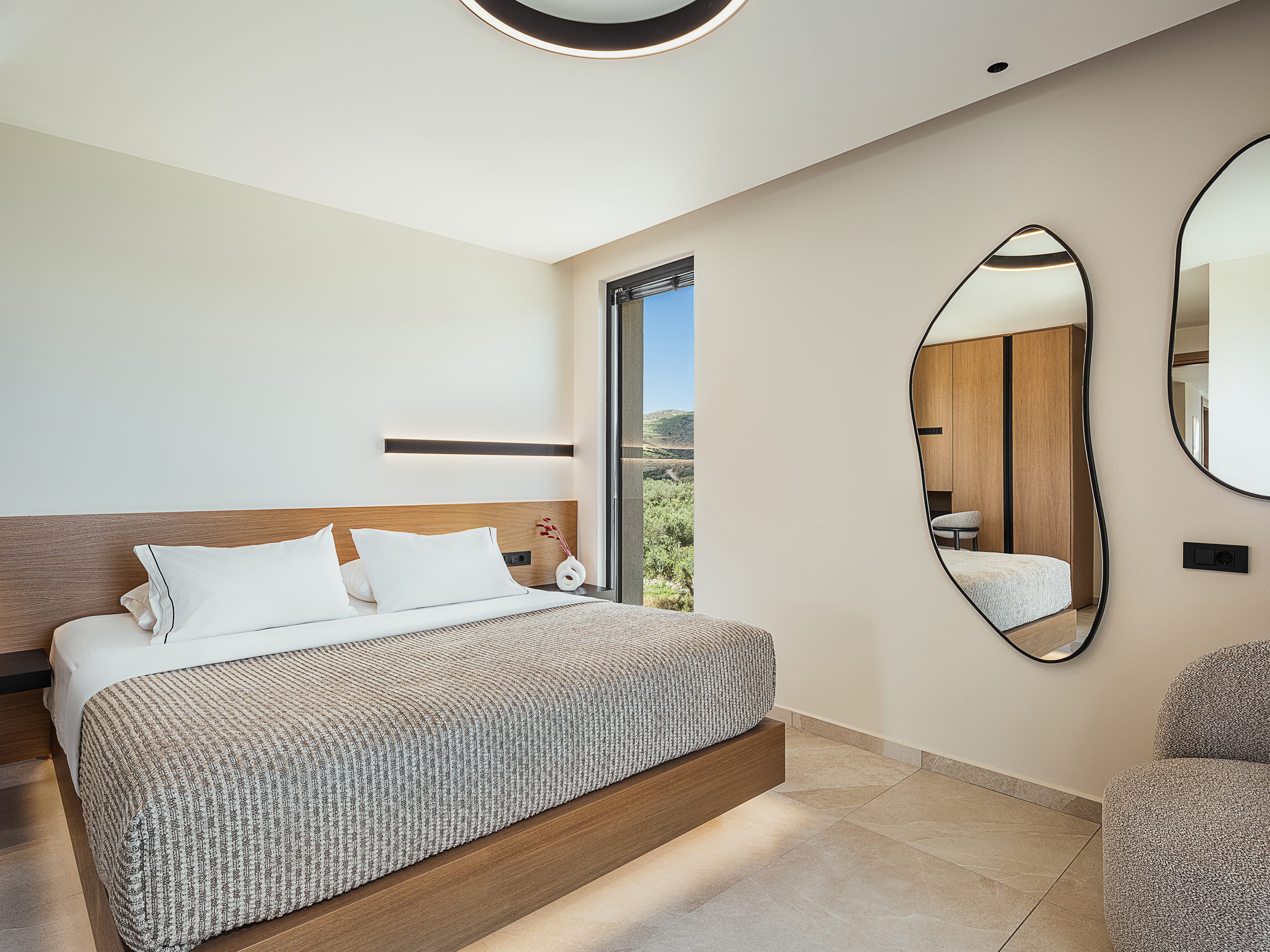 a bedroom with a large mirror