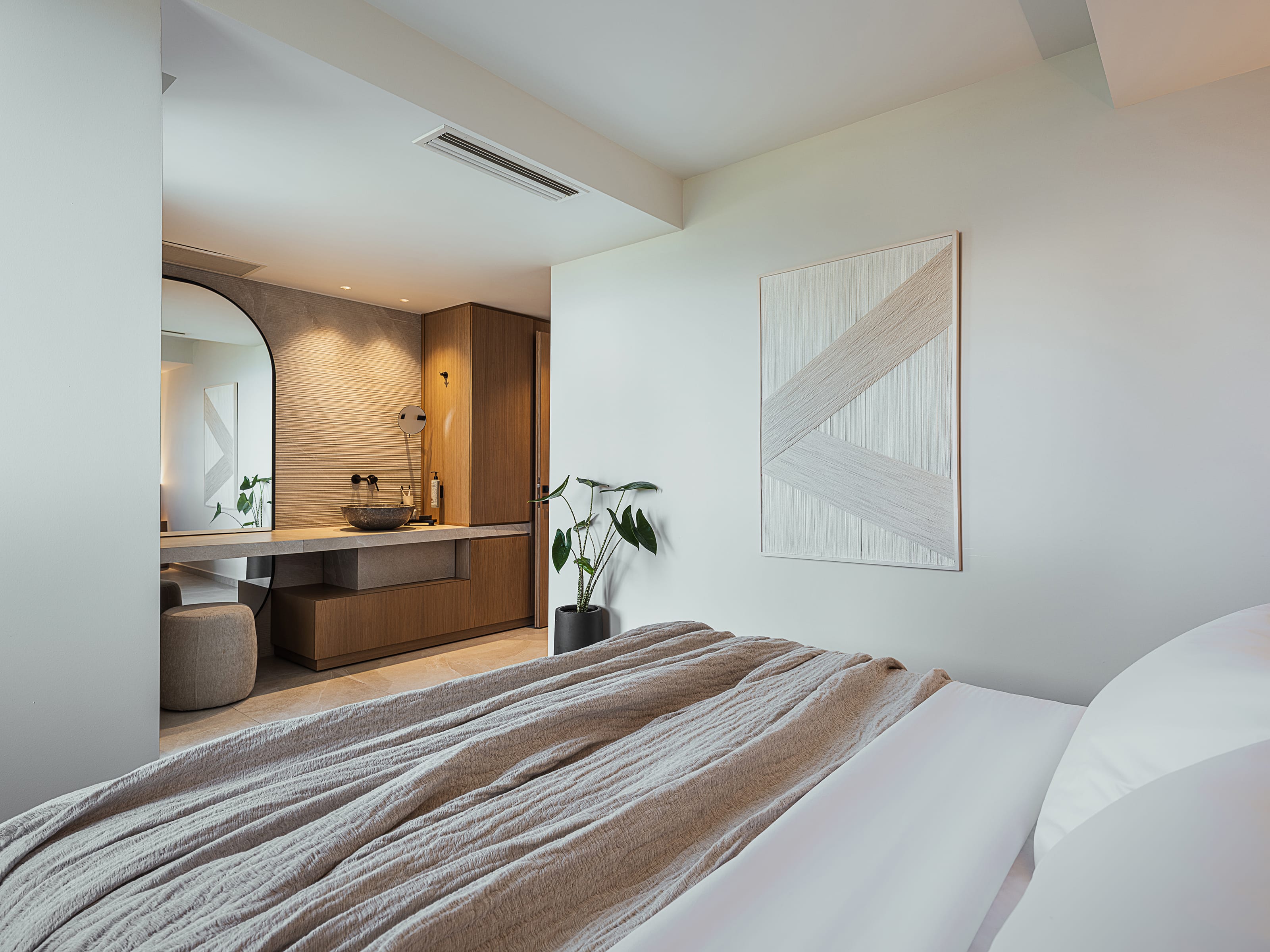 a room with a bed and a plant