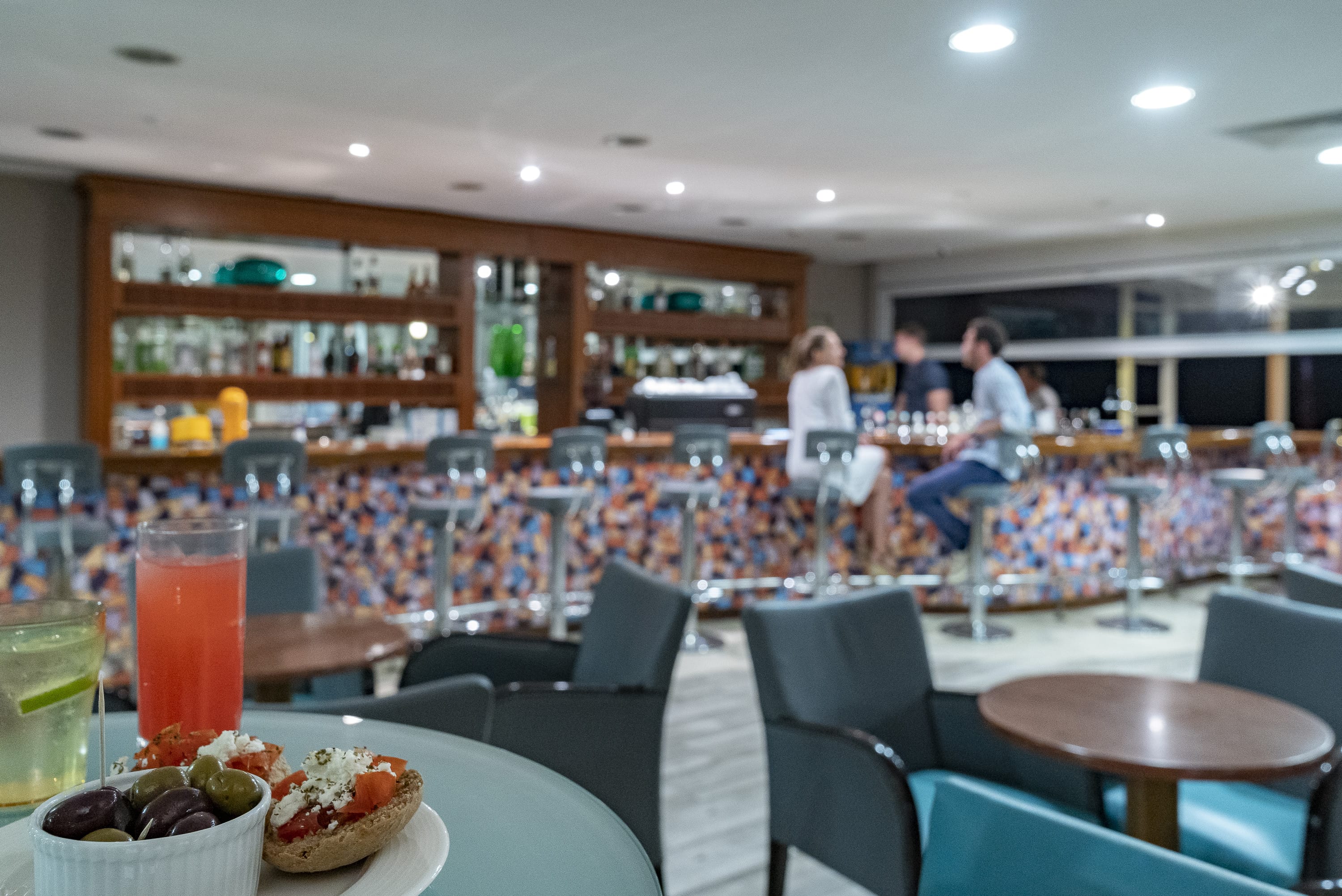 a restaurant with a large table and chairs