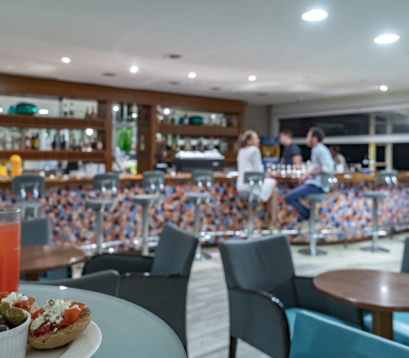 a restaurant with a large table and chairs