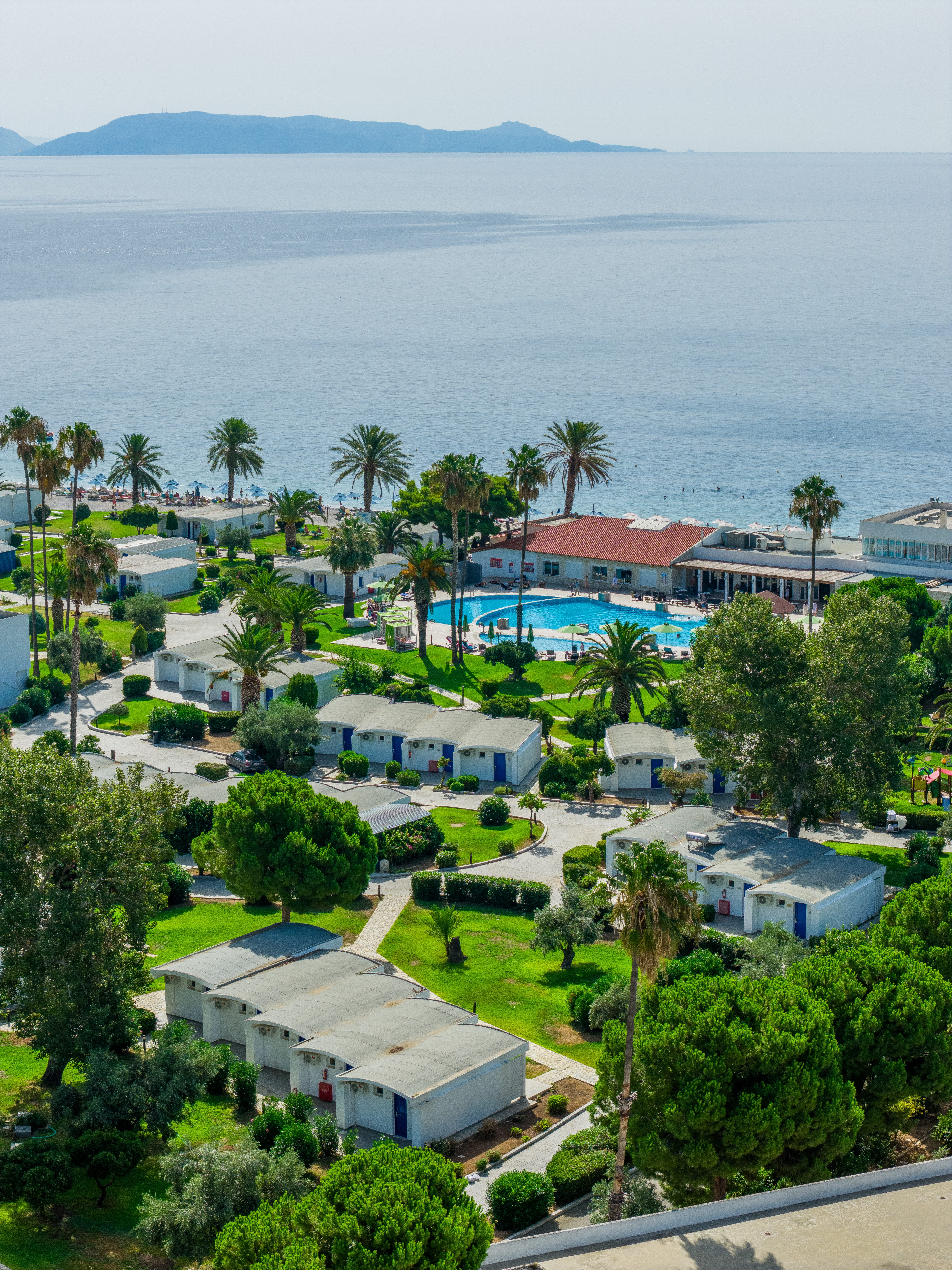 a group of houses with a pool and trees