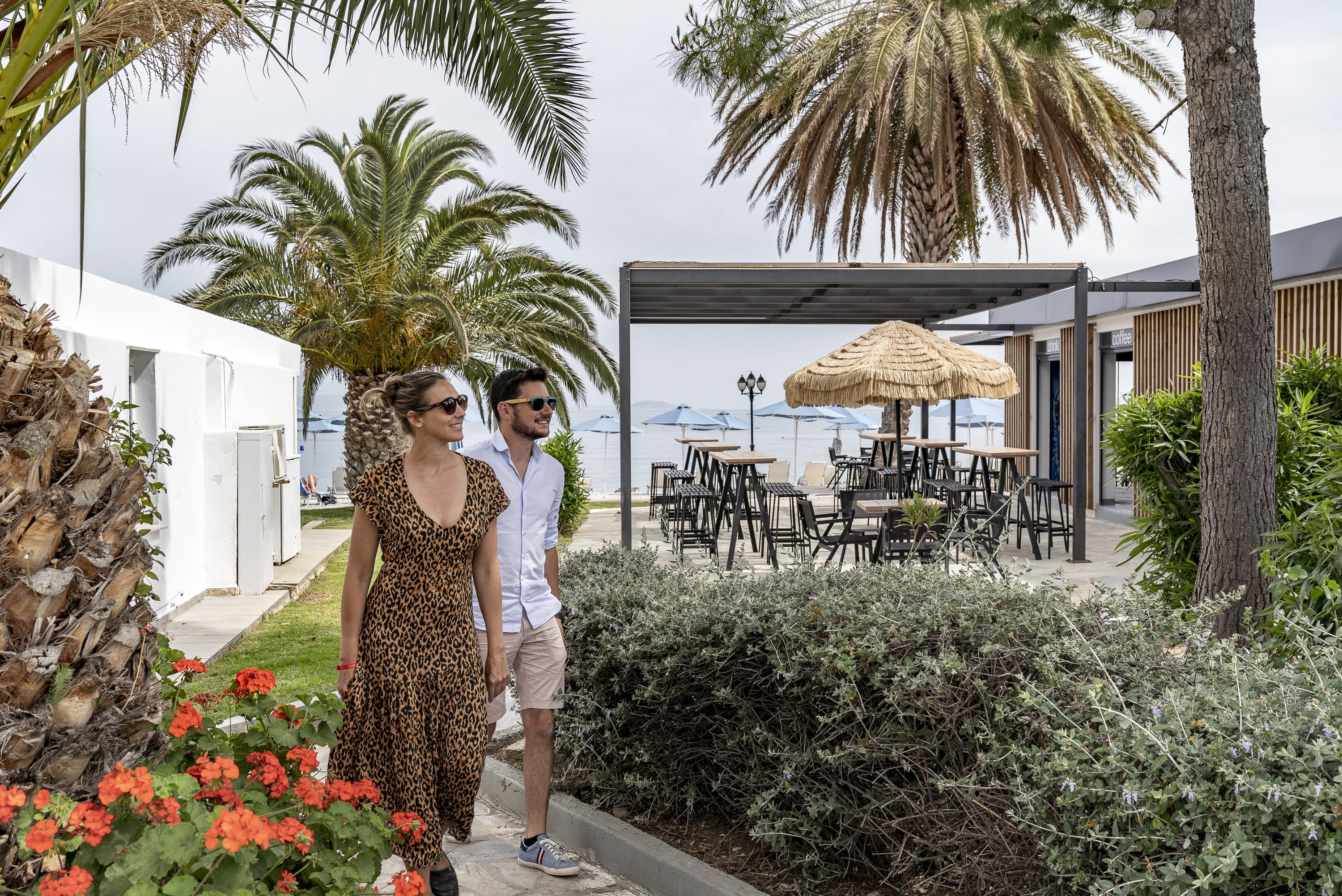 a man and woman posing for a picture in a garden