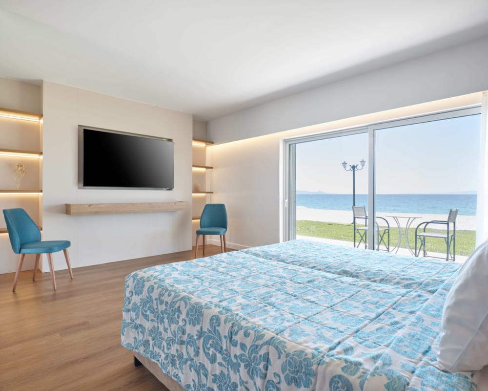 a bedroom with a large bed and a tv