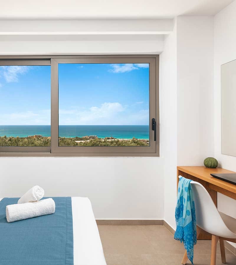 a room with a window and a bed