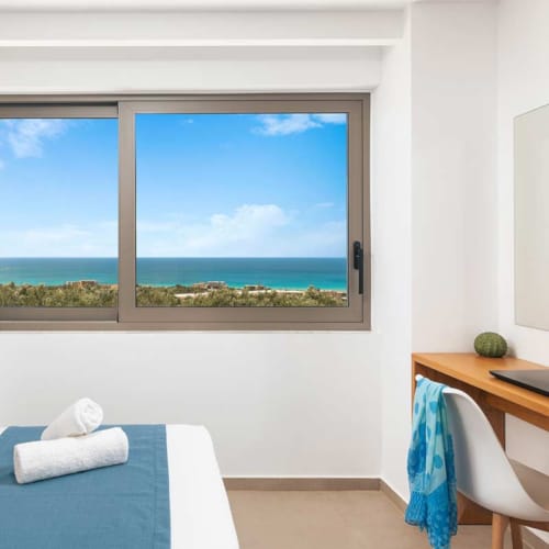 a room with a window and a bed