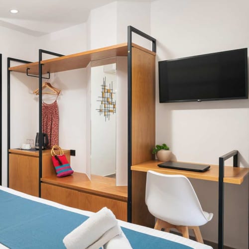 a room with a bed and a tv