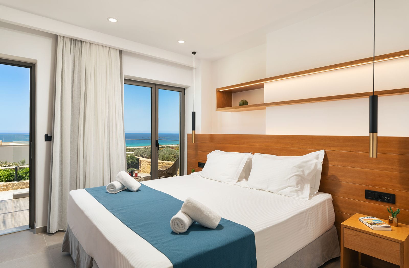 a bed with white sheets and pillows