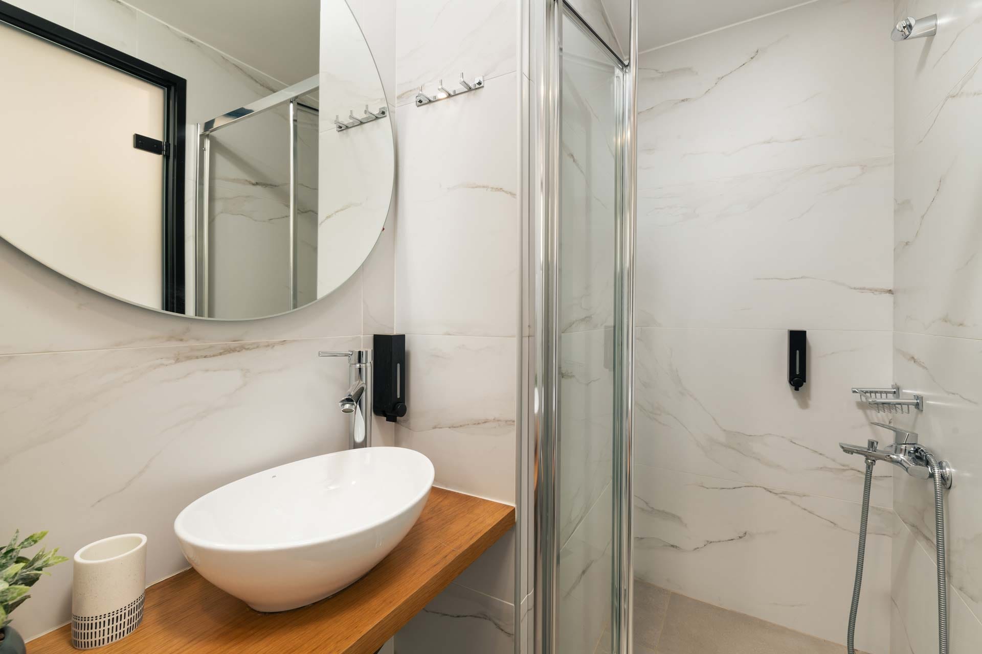 a bathroom with a sink and a shower unit