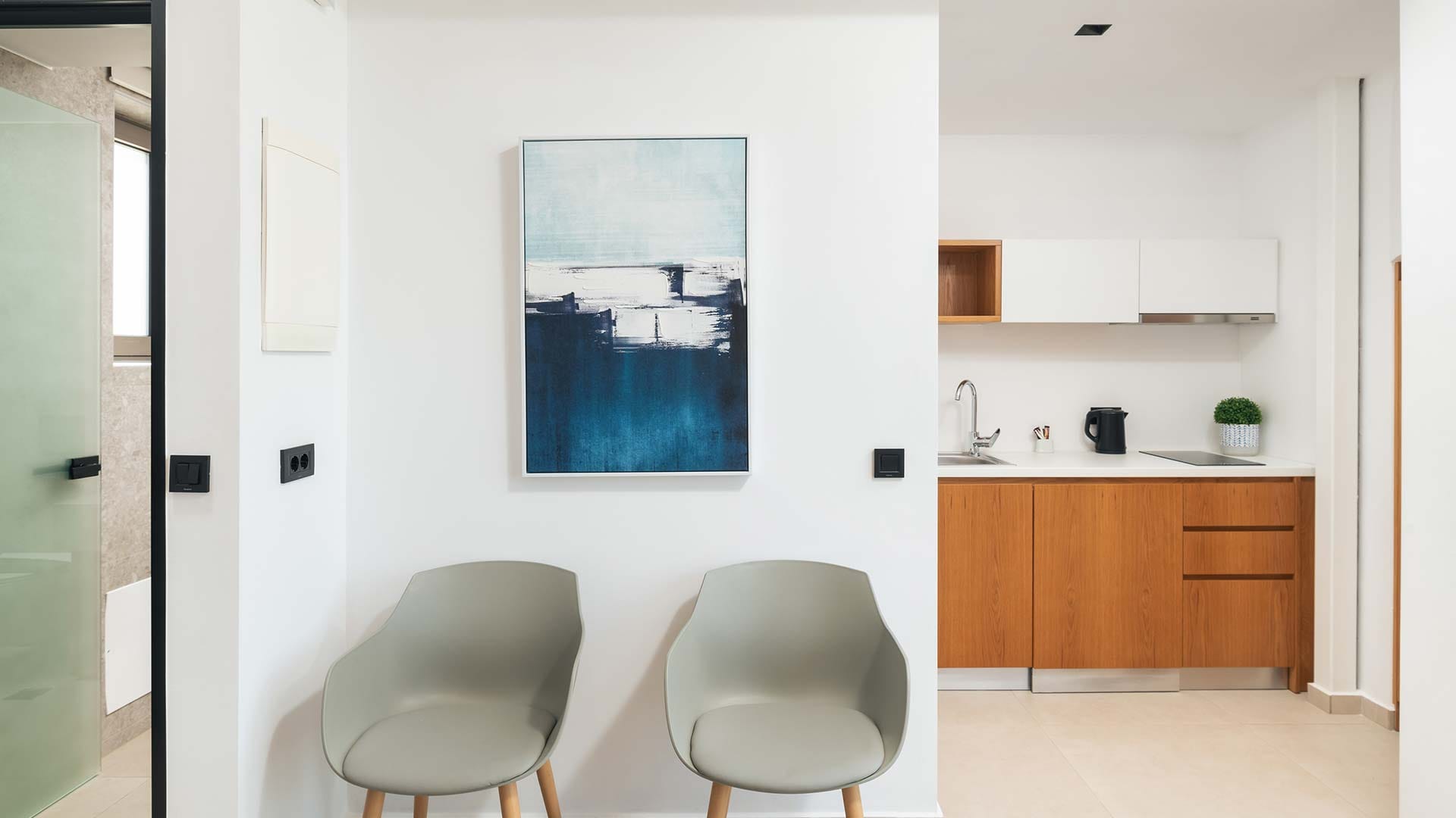 a room with a chair and a painting on the wall