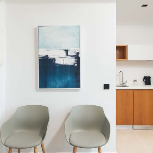 a room with a chair and a painting on the wall