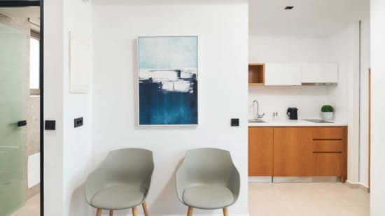 a room with a chair and a painting on the wall