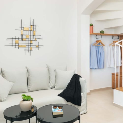 a room with a bed and a table with a lamp on it