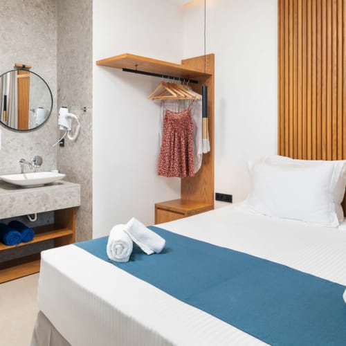 a bathroom with a bed and a sink